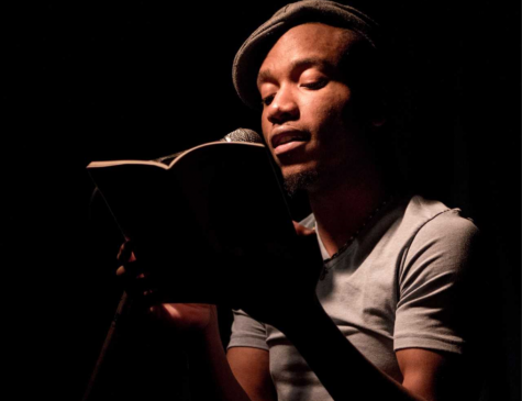 Donte Collins reads their poetry on stage. Image supplied by Collins. 