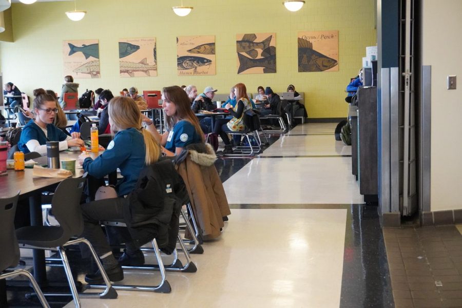 Anoka-Ramsey community members sitting in the Riverside Cafe on the Coon Rapids campus. Aladdin Food Services supplies the food for this cafe. 