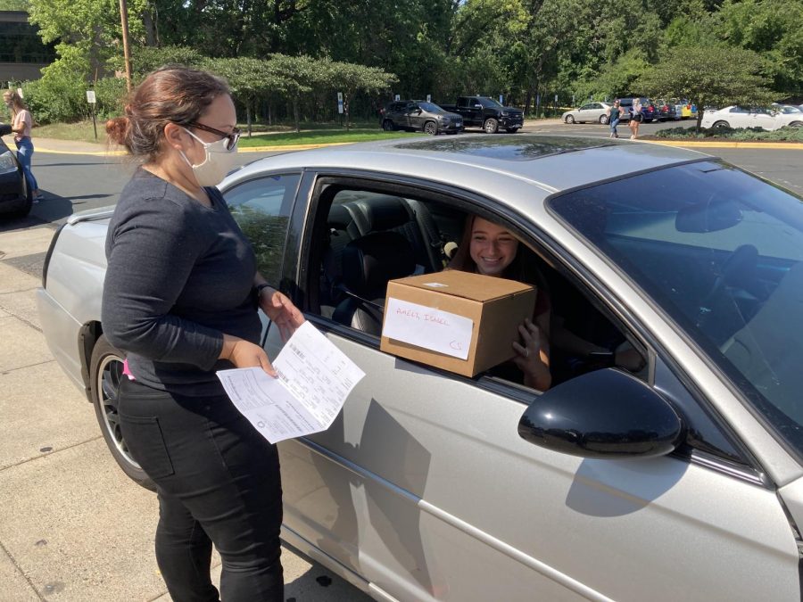 Student receiving a box through their car window