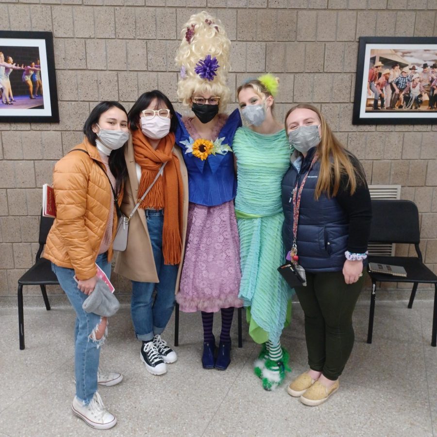 A group of people, some in costume, pose for a photograph.